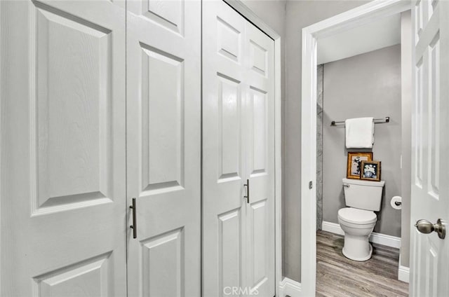 bathroom featuring hardwood / wood-style flooring and toilet