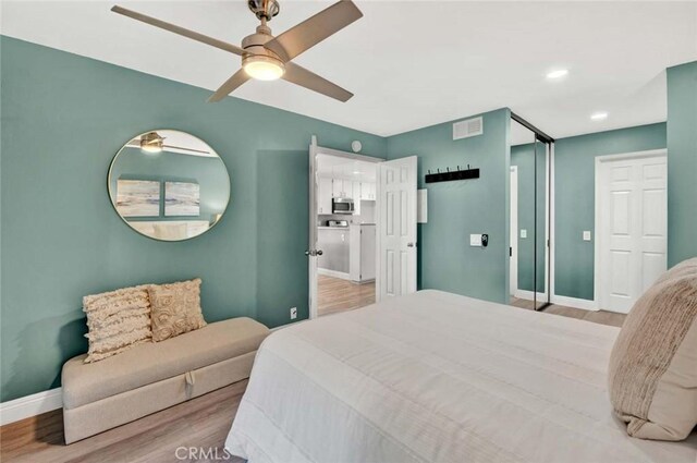 bedroom featuring ceiling fan and light hardwood / wood-style floors