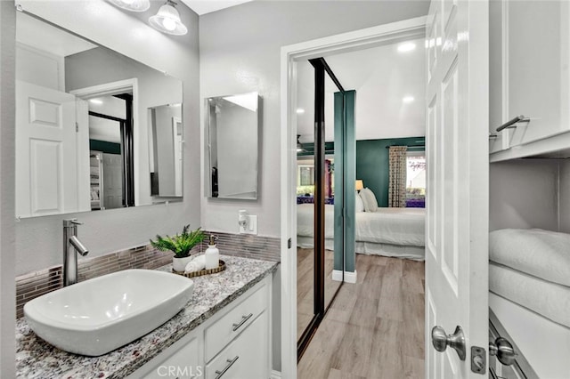 bathroom featuring hardwood / wood-style floors and vanity