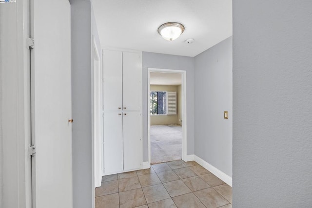 hallway featuring light tile patterned flooring