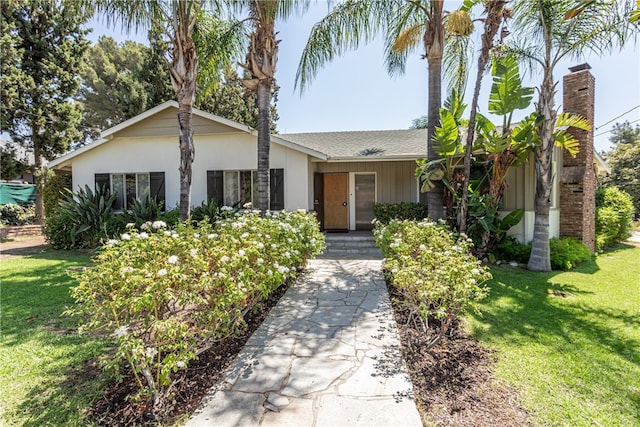 ranch-style home featuring a front yard