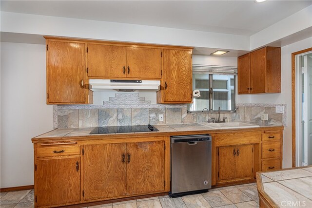 kitchen with sink, tasteful backsplash, dishwasher, tile counters, and black electric stovetop