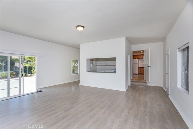 unfurnished living room with light hardwood / wood-style flooring