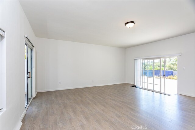 spare room featuring light hardwood / wood-style flooring and a wealth of natural light