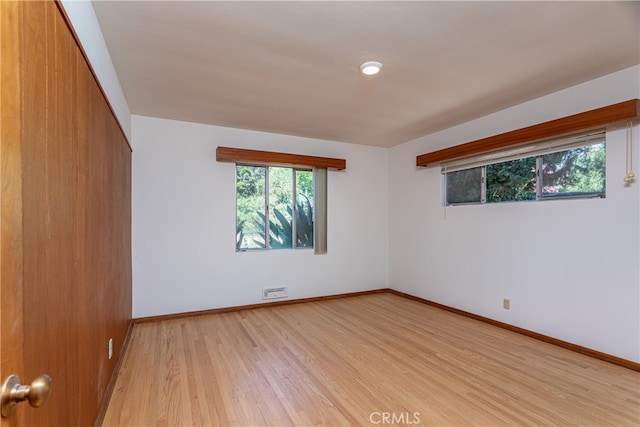 spare room featuring light hardwood / wood-style floors