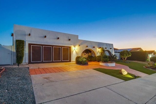 pueblo-style house featuring a garage