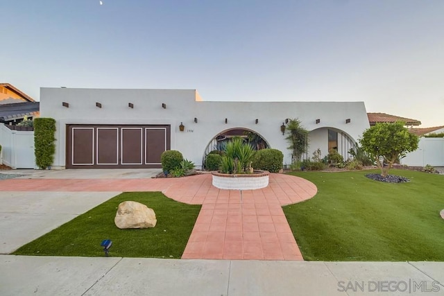 view of front of property featuring a front yard and a garage