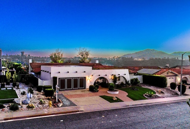 view of front of house with a mountain view and a garage