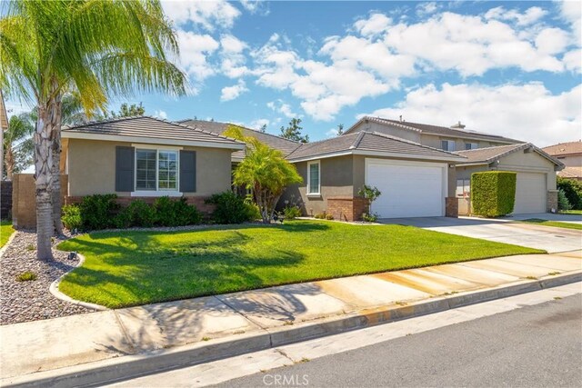 ranch-style house featuring a front lawn and a garage