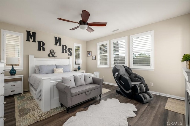 bedroom featuring ceiling fan, dark wood finished floors, visible vents, and baseboards