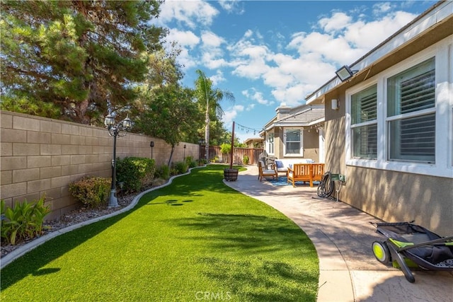 view of yard featuring a patio and a fenced backyard