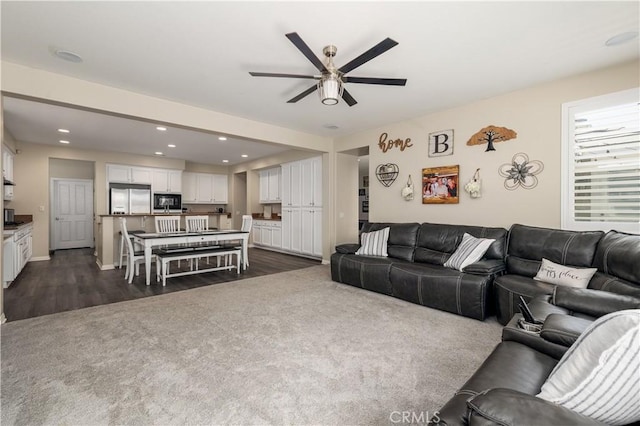 living area featuring ceiling fan, dark wood finished floors, and recessed lighting