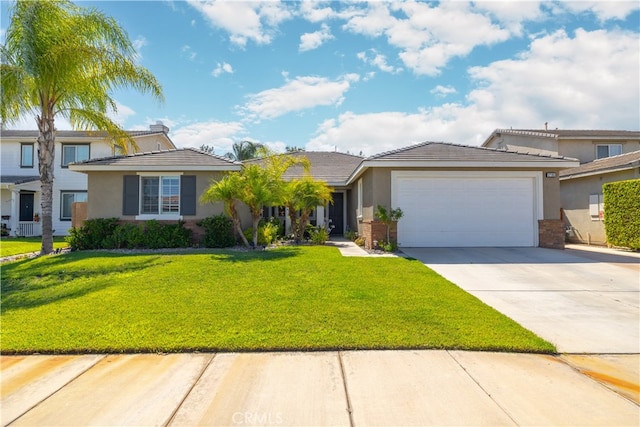 view of front of property featuring a garage and a front yard