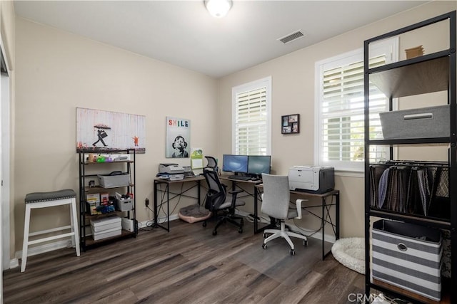 home office featuring wood finished floors, visible vents, and baseboards