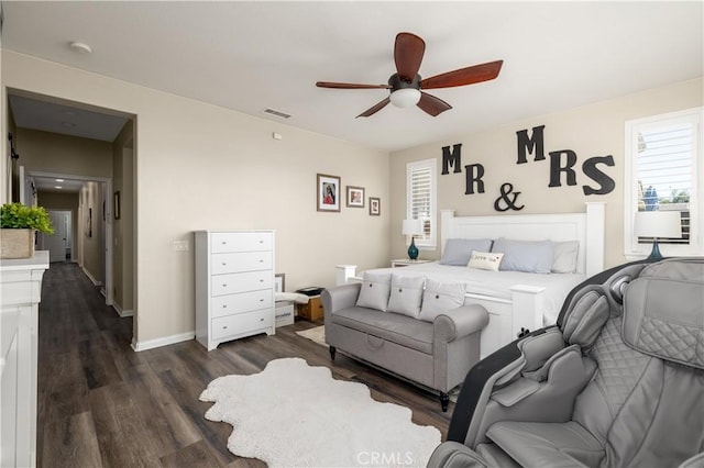 bedroom featuring ceiling fan, dark wood finished floors, visible vents, and baseboards