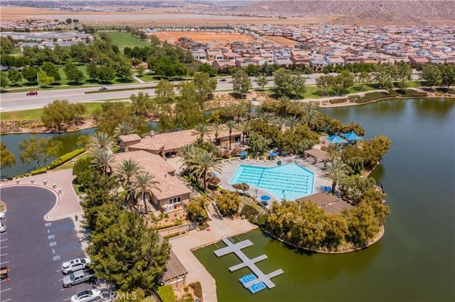 drone / aerial view with a water view and a residential view