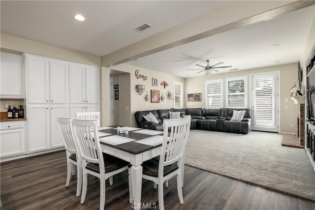 dining space featuring visible vents, ceiling fan, dark wood-style flooring, a fireplace, and recessed lighting