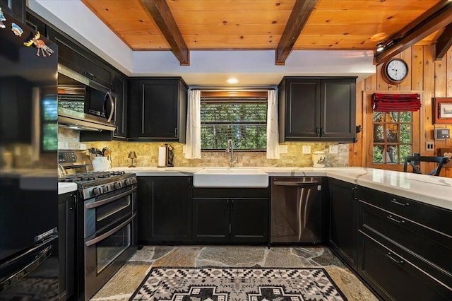 kitchen featuring beamed ceiling, tasteful backsplash, sink, and stainless steel appliances