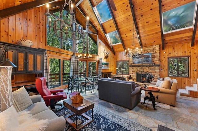 tiled living room featuring a skylight, a fireplace, high vaulted ceiling, and wooden walls