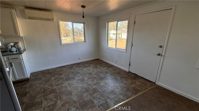 unfurnished dining area featuring an AC wall unit