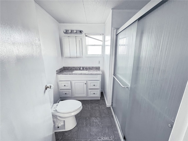 bathroom featuring vanity, an enclosed shower, toilet, and tile patterned flooring