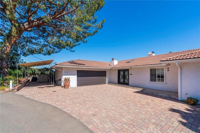 view of front of house with french doors and a garage