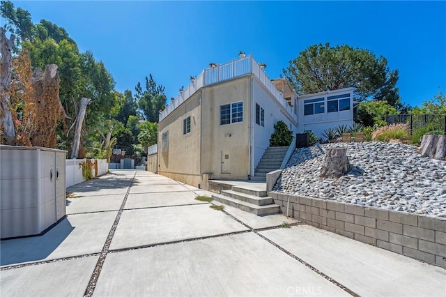 rear view of property featuring a balcony