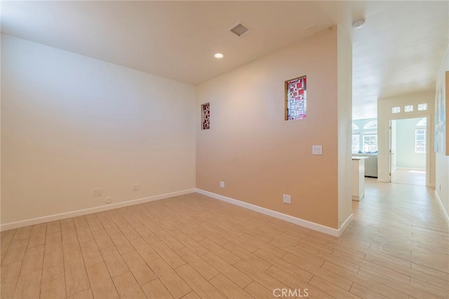 spare room featuring light hardwood / wood-style floors