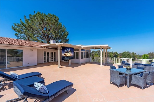 view of patio / terrace featuring french doors and a sunroom