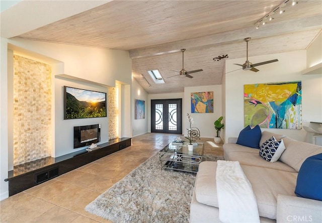 living room with ceiling fan, french doors, track lighting, and vaulted ceiling