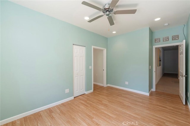 empty room with light hardwood / wood-style flooring and ceiling fan