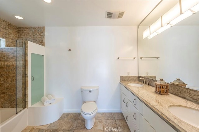 full bathroom featuring vanity, enclosed tub / shower combo, and toilet