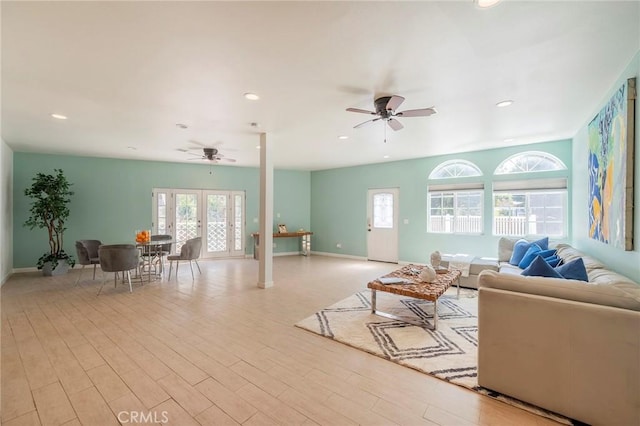 living room with light wood-type flooring and ceiling fan