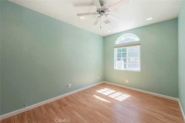 spare room featuring ceiling fan and light wood-type flooring