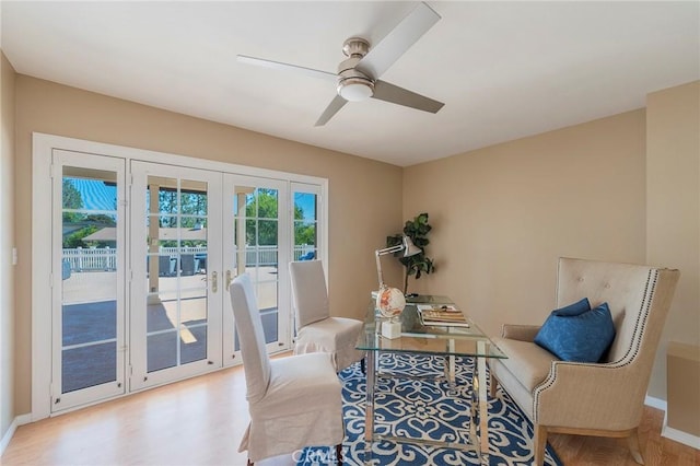 sitting room with ceiling fan, french doors, and light wood-type flooring