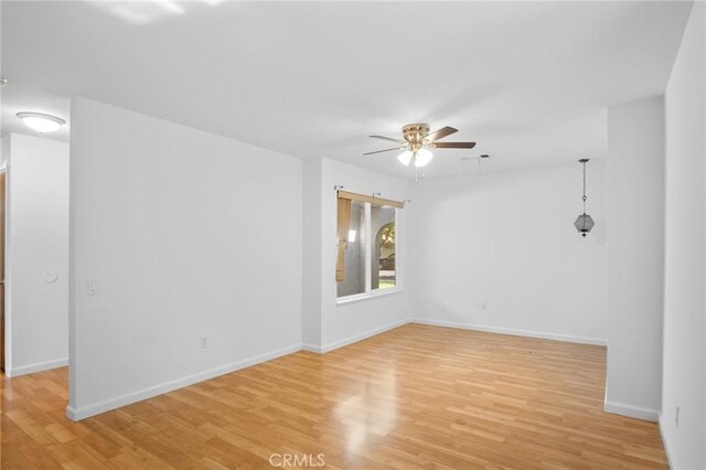 unfurnished room with ceiling fan and light hardwood / wood-style flooring