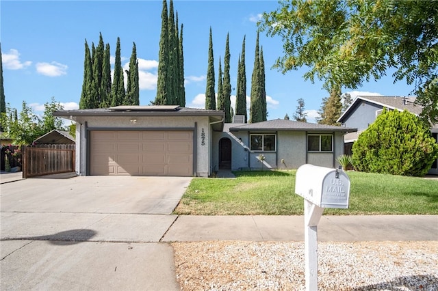 ranch-style house featuring a front lawn and a garage