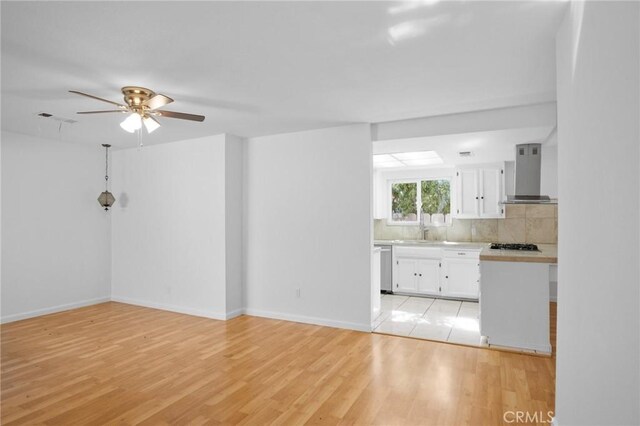 interior space featuring ceiling fan and light wood-type flooring