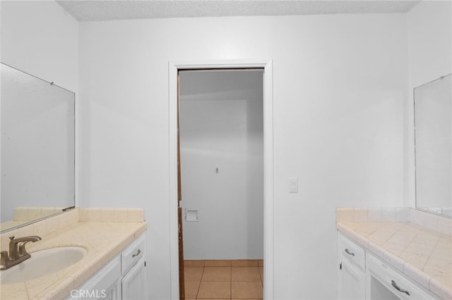 bathroom with tile patterned floors and vanity