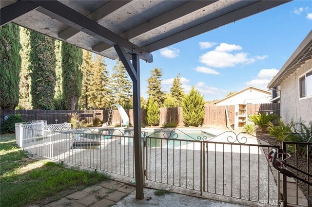 view of patio with a fenced in pool