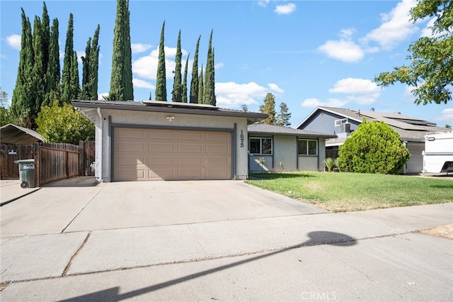 ranch-style house with a front lawn, solar panels, and a garage