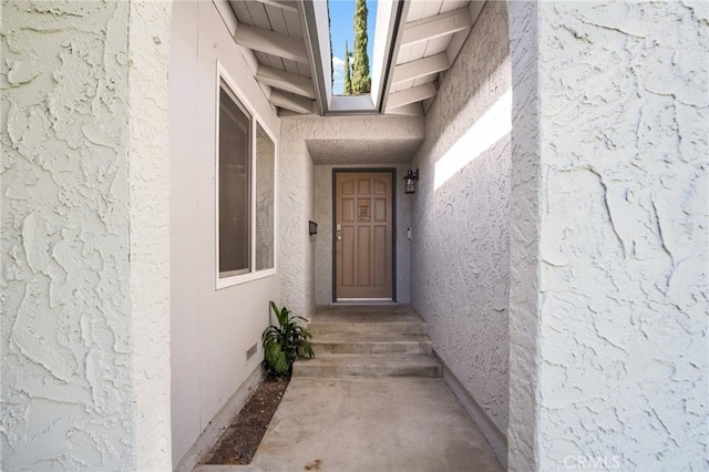 doorway to property with stucco siding