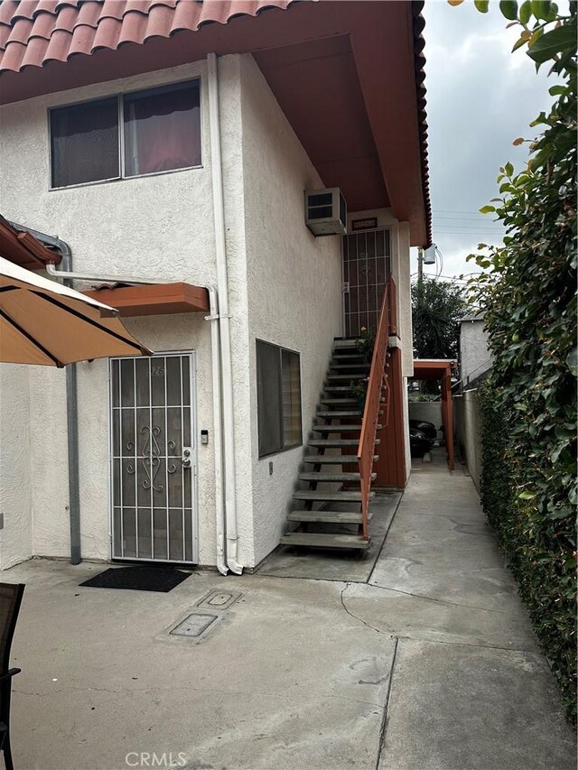 924 W Clark Ave, Burbank, CA 91506 - rear view of house featuring stucco siding, a tile roof, a patio area, and stairs