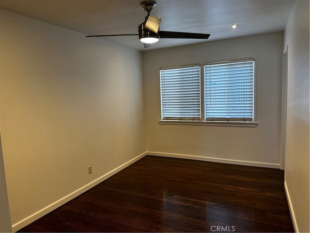 spare room featuring ceiling fan and dark hardwood / wood-style floors