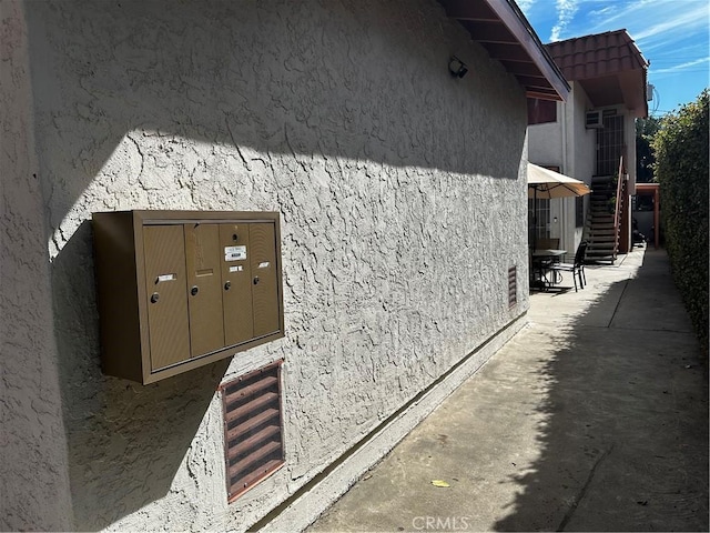 924 W Clark Ave, Burbank, CA 91506 - view of side of property with mail area, stucco siding, and stairway