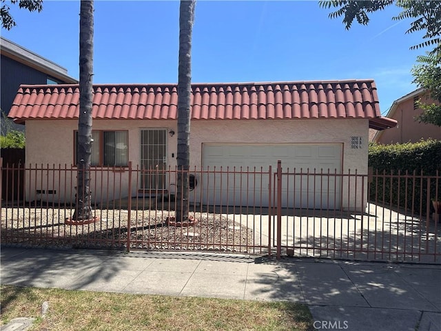 924 W Clark Ave, Burbank, CA 91506 - view of front of home with a garage, a tile roof, and stucco siding