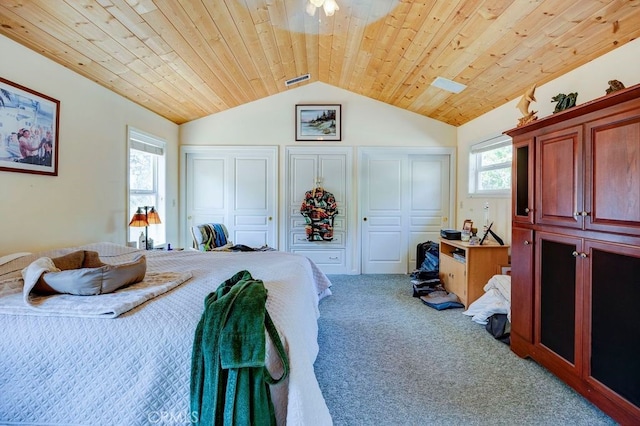 carpeted bedroom with wooden ceiling and vaulted ceiling