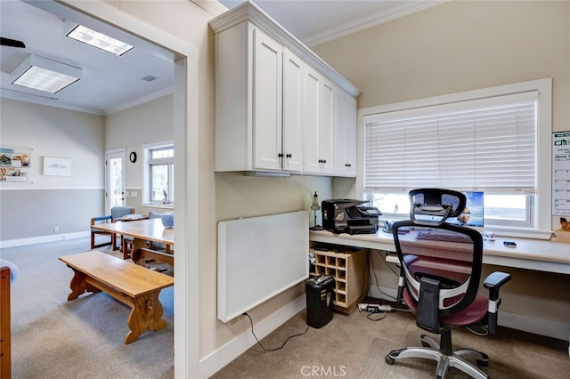 carpeted office space featuring crown molding