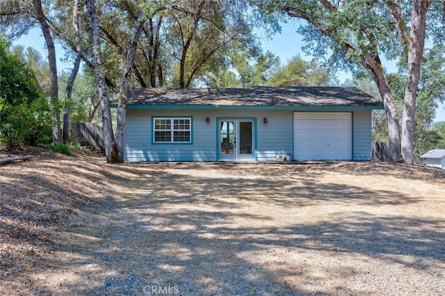 ranch-style house with french doors and a garage