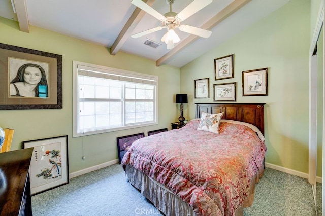 carpeted bedroom with ceiling fan and vaulted ceiling with beams